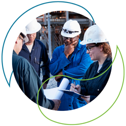 Four people standing around in hard hats