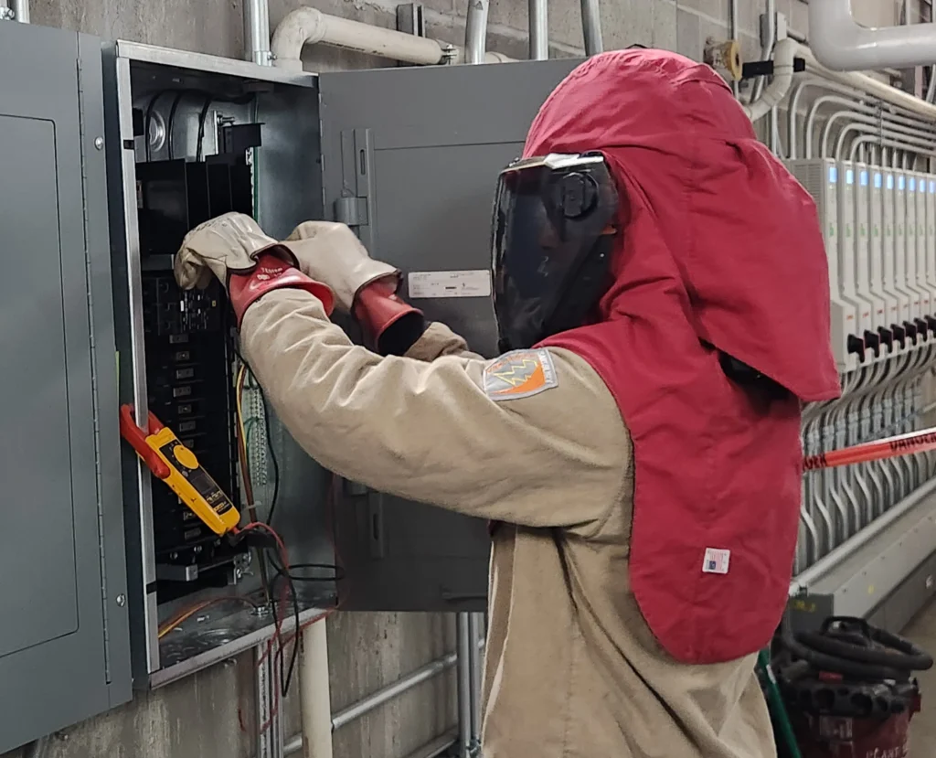 A person checking eletrical boxes
