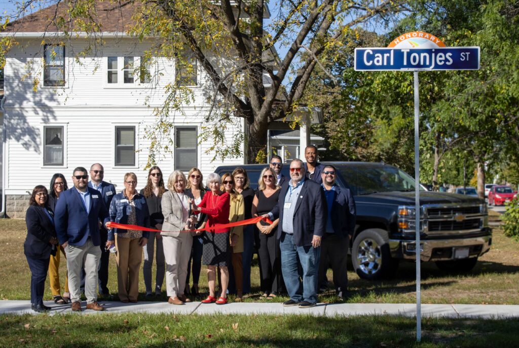A large group outside for a street ribbon cutting