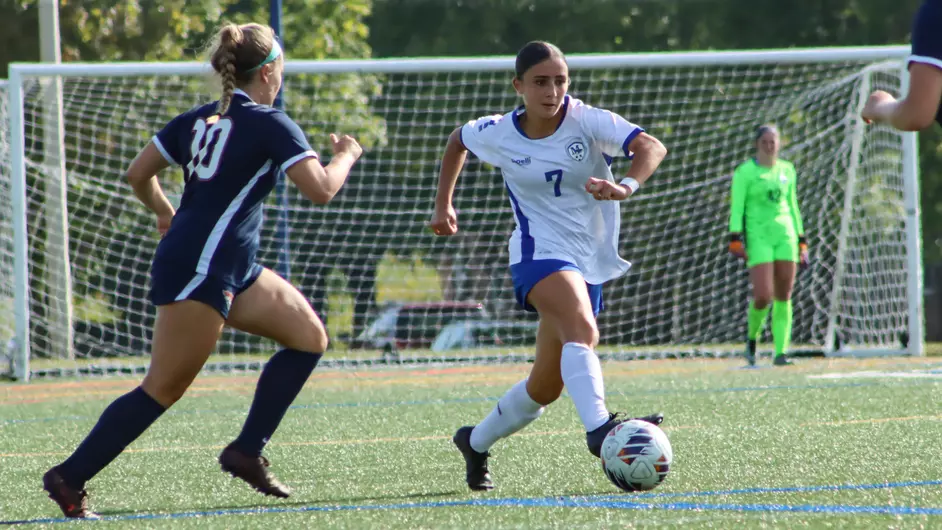 Women playing college soccer