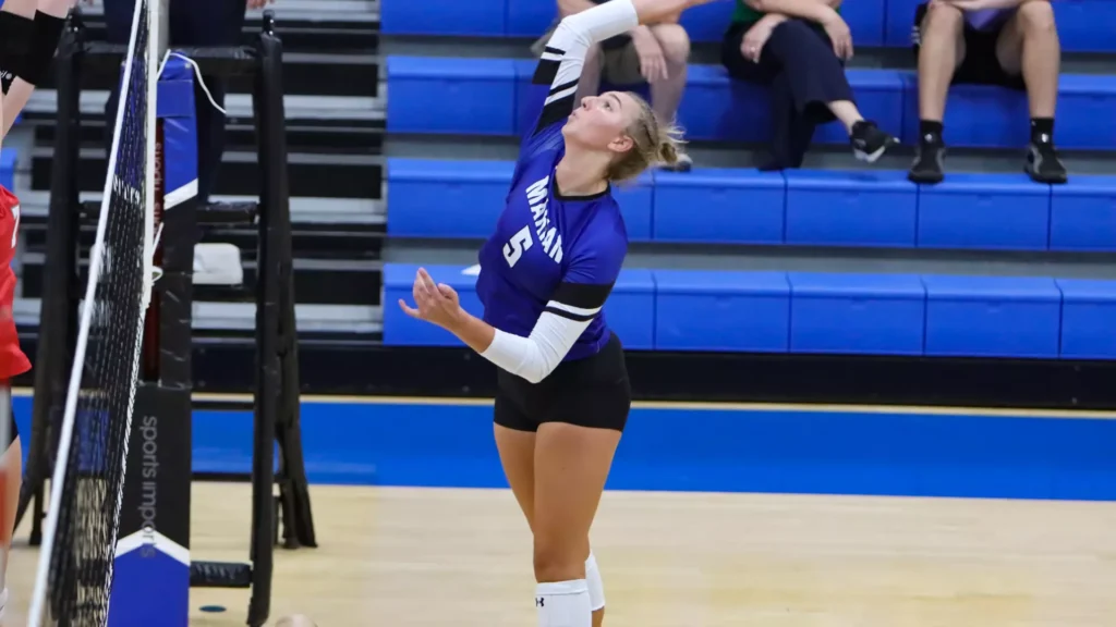 women playing college volleyball