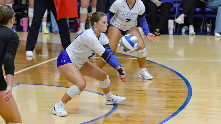 Women playing college volleyball