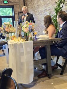 A man giving a speech at a wedding