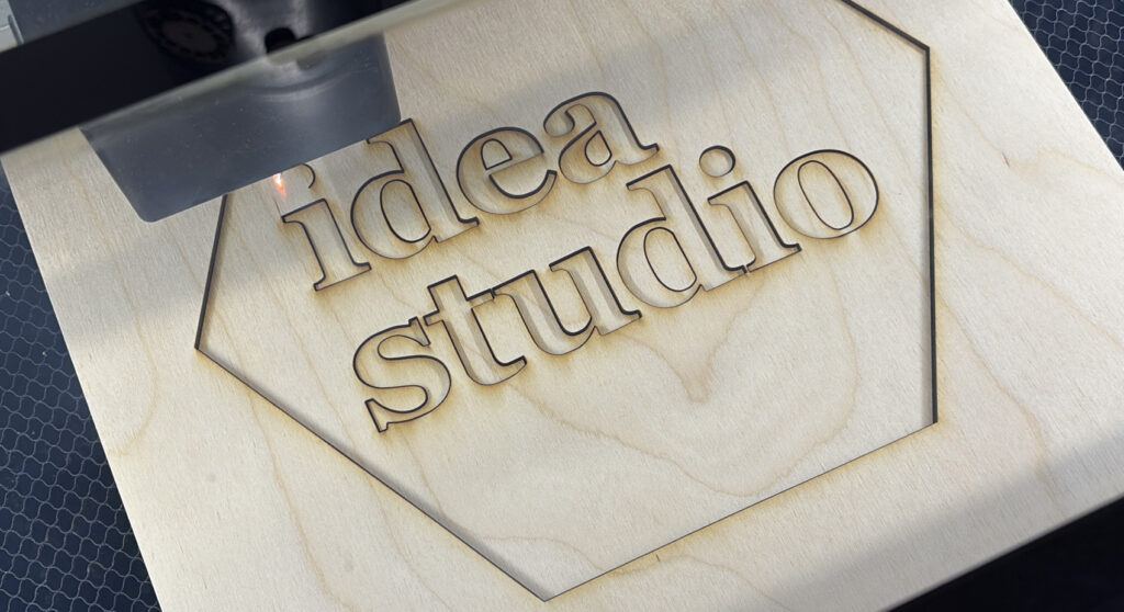 Idea studio being burned into a block of wood