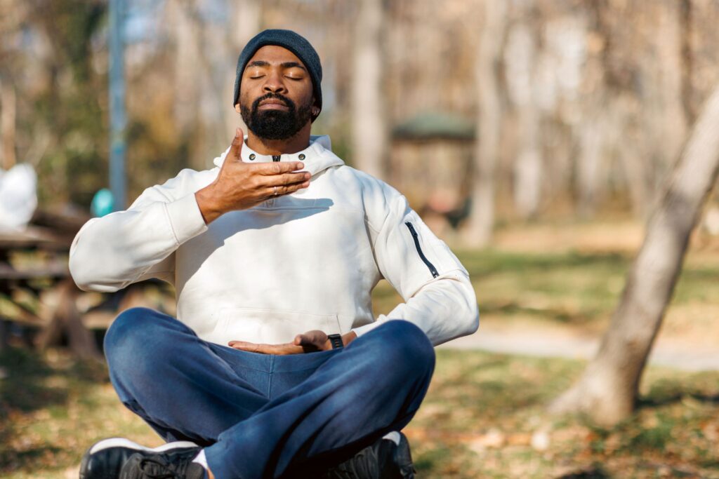 A man sitting on the ground meditating