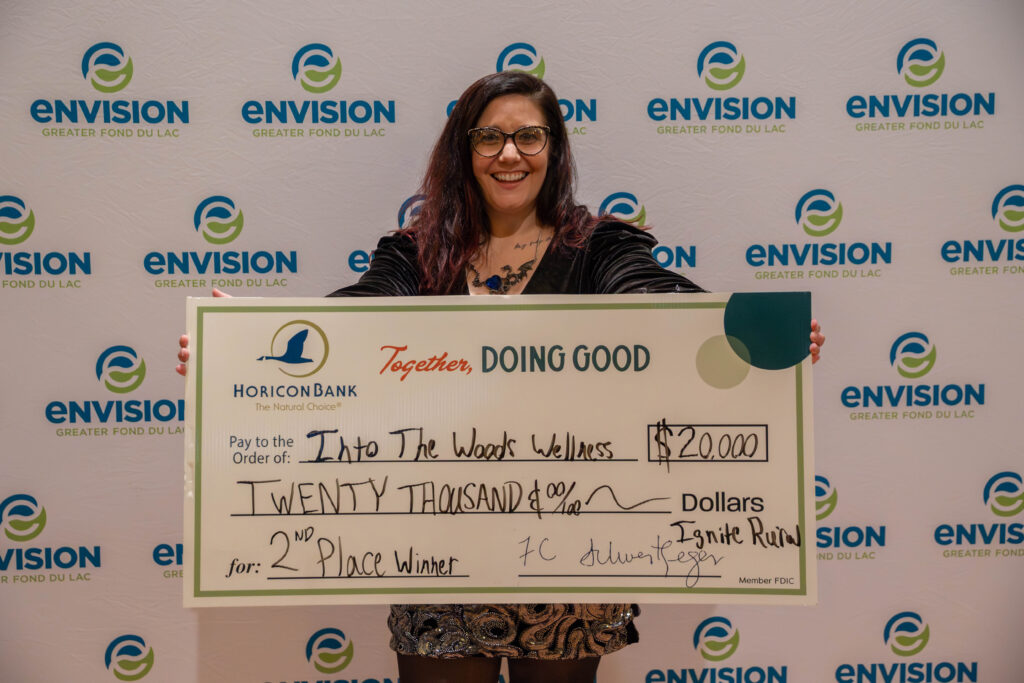 A smiling woman with a big check