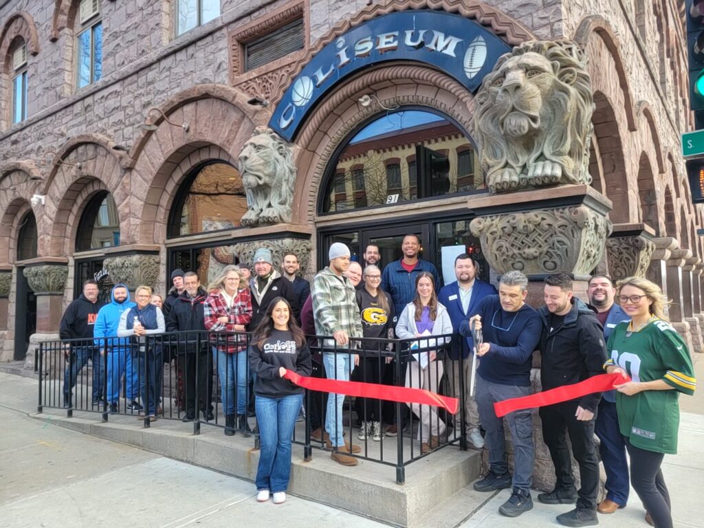 A group of people outside for a ribbon cutting