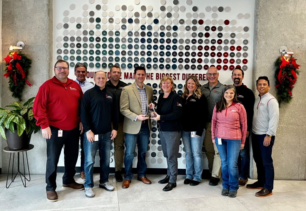 A group of eleven people receiving an award