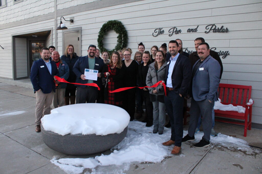 A large group outside for a ribbon cutting