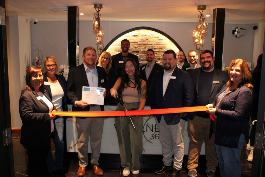 A group of people inside for a ribbon cutting