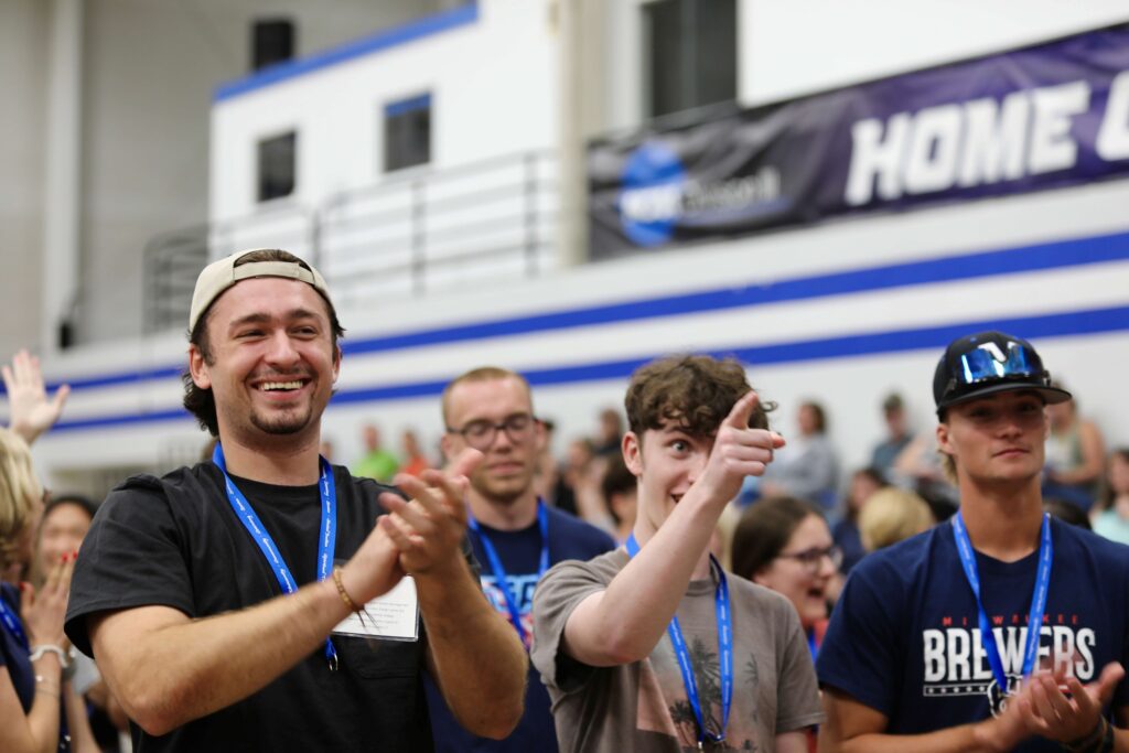 A group of college students standing in a gym