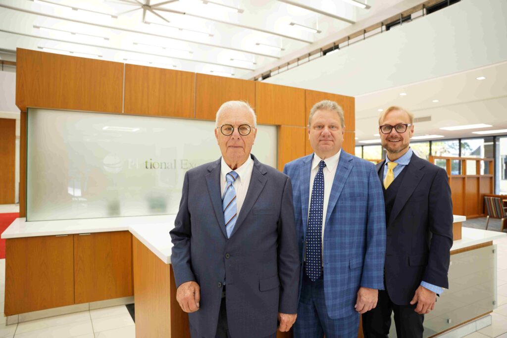 Three men in suits in a bank