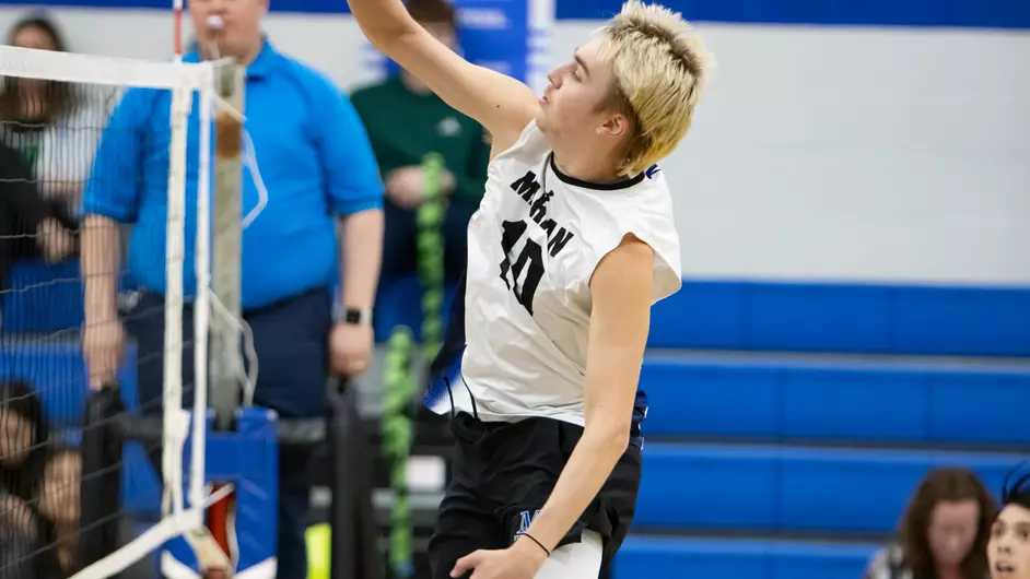 Men playing college volleyball
