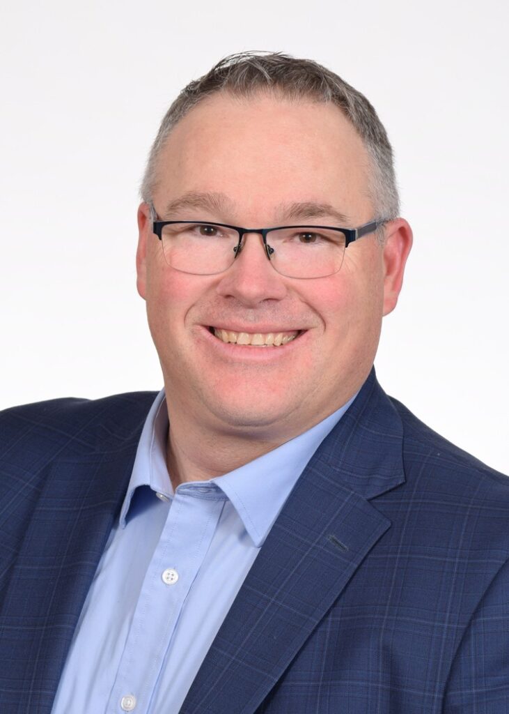 A business man with glasses and a suit coat