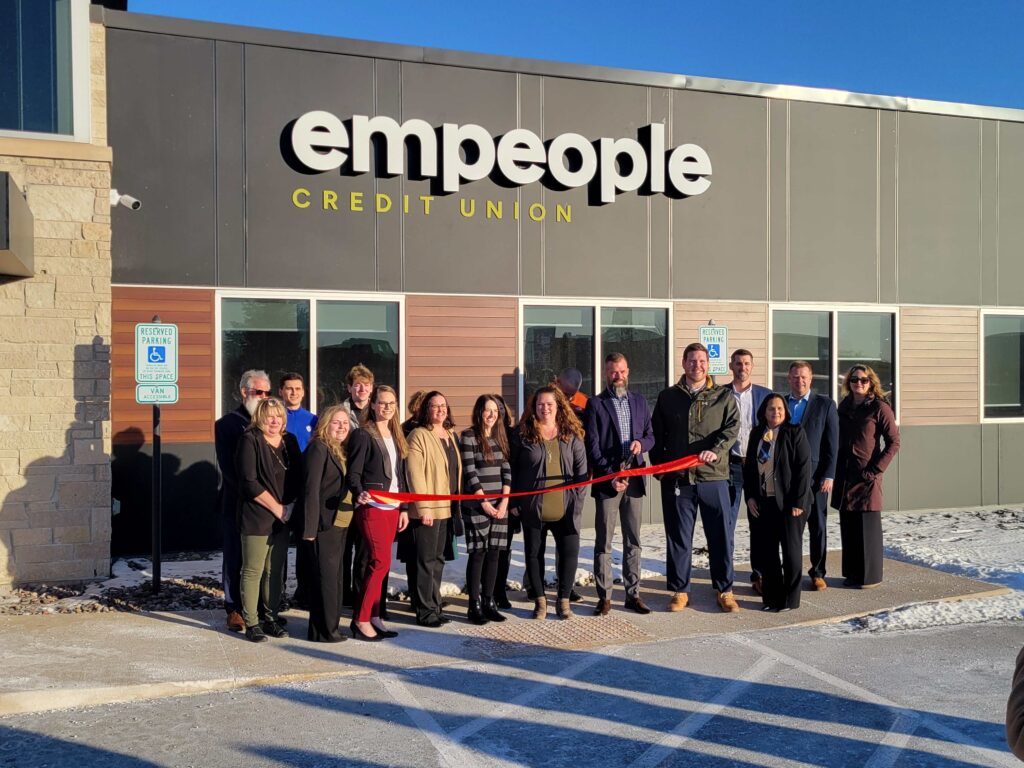 A group of people outside for a ribbon cutting