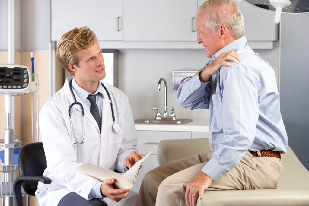 An older man talking to a doctor