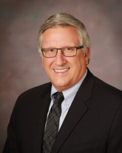 An older gentleman in a suit and tie