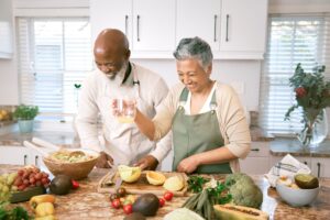 A man and a woman cooking in a kitchen
