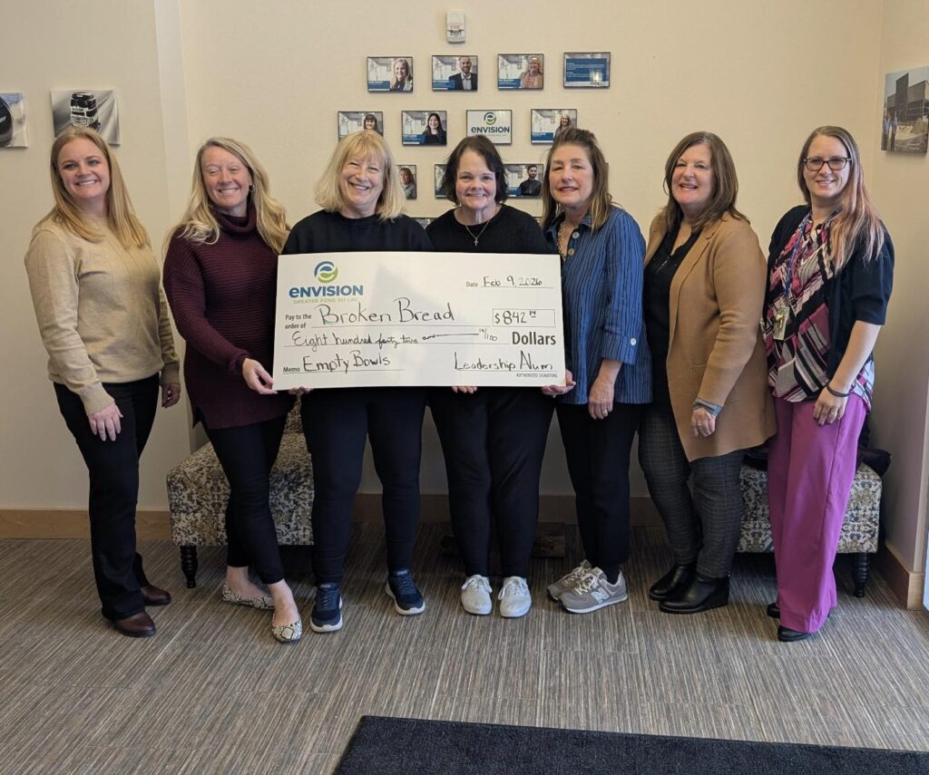 Seven people receiving a big check