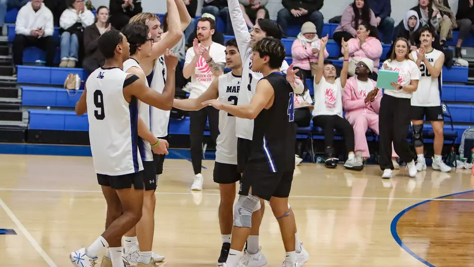 Men playing college volleyball
