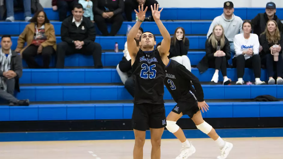 Men playing college volleyball
