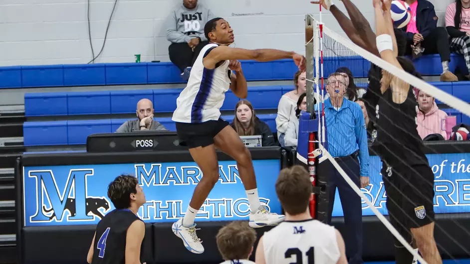 Men playing college volleyball