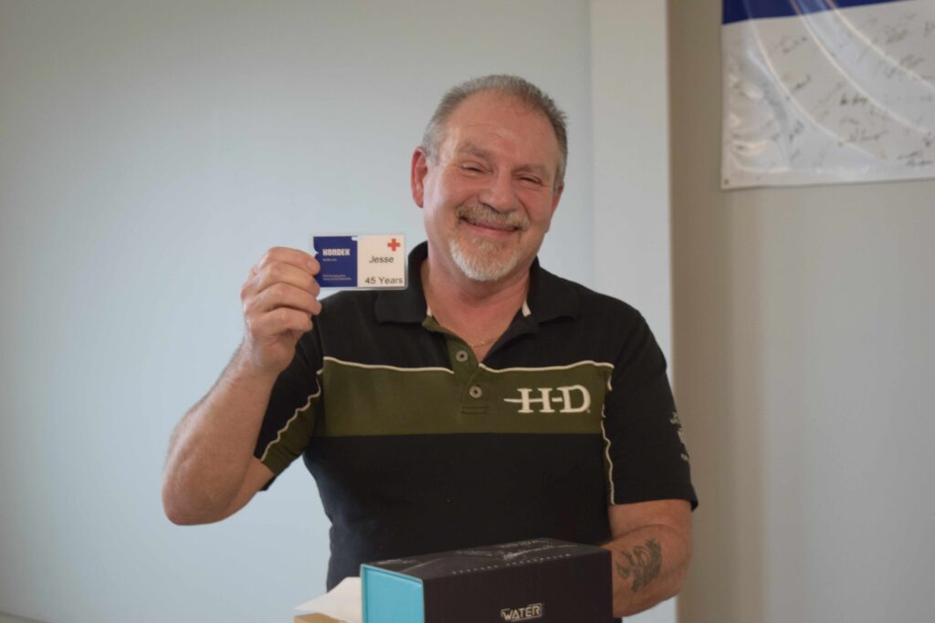 An older man holding a card