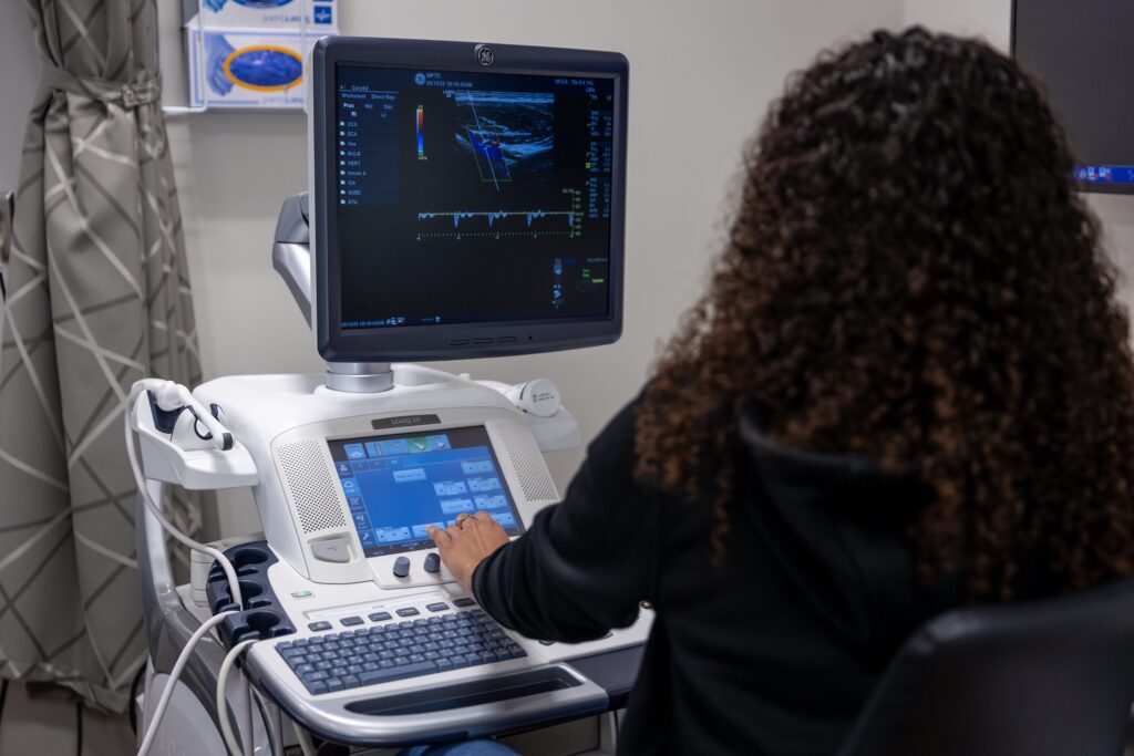 A woman at a sonogram machine