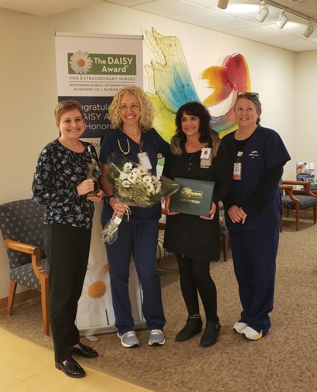 Four nurses with an award