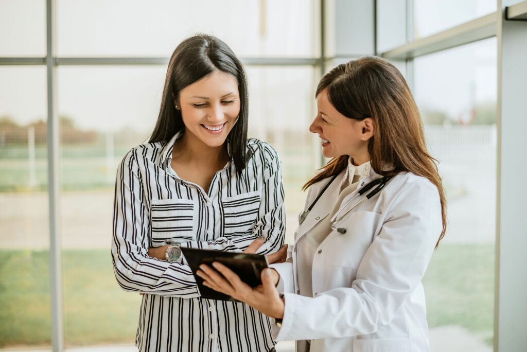 A young female patient talking to a female doctor