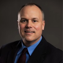 A smiling middle aged man