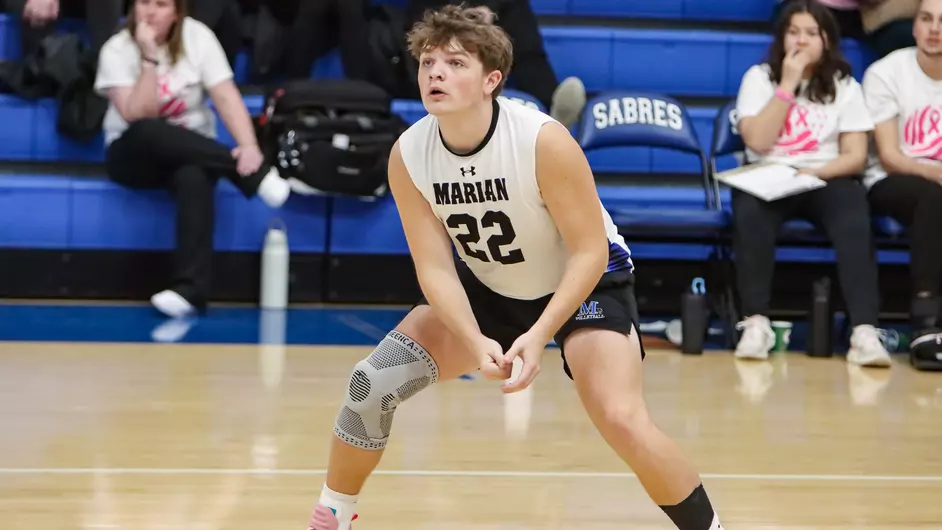 Men playing college volleyball