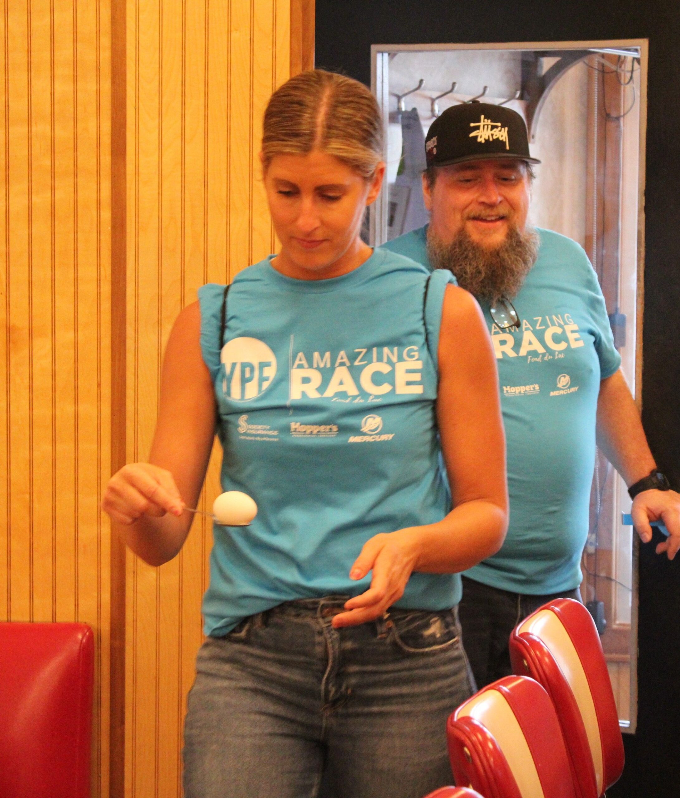 A woman competing in a race carrying an egg