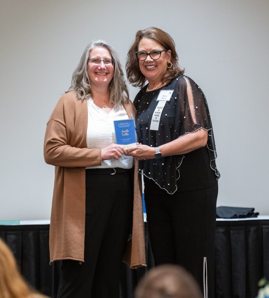 Two women with one getting an award