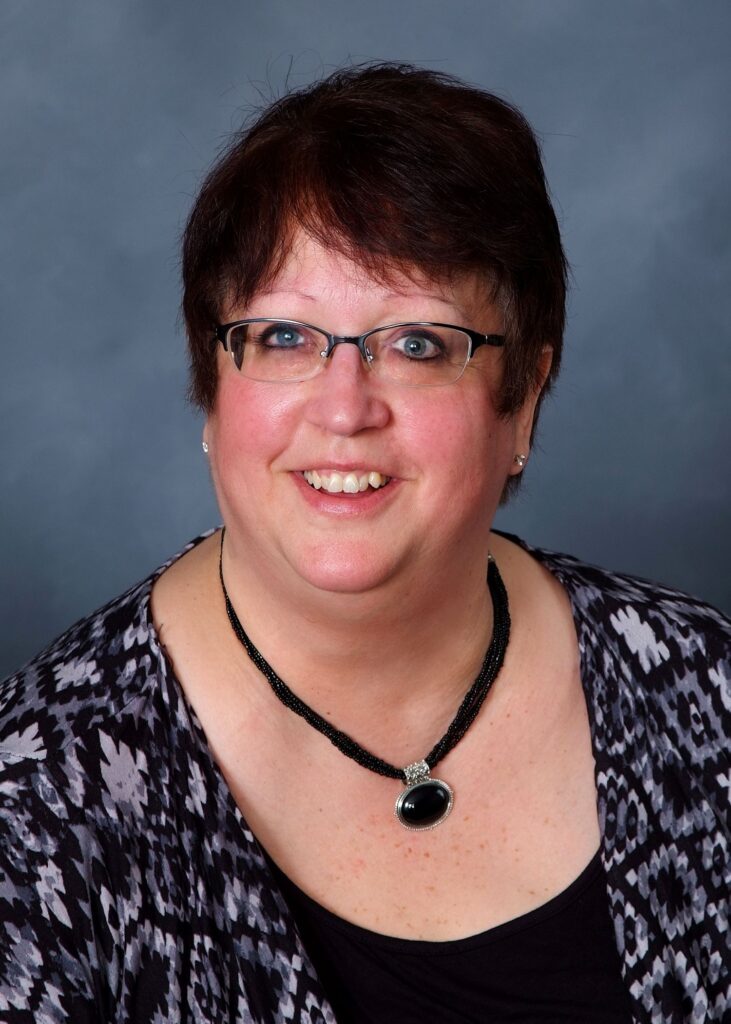 A smiling middle aged woman