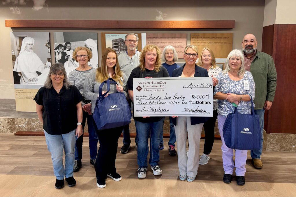 A group of people inside with a big check