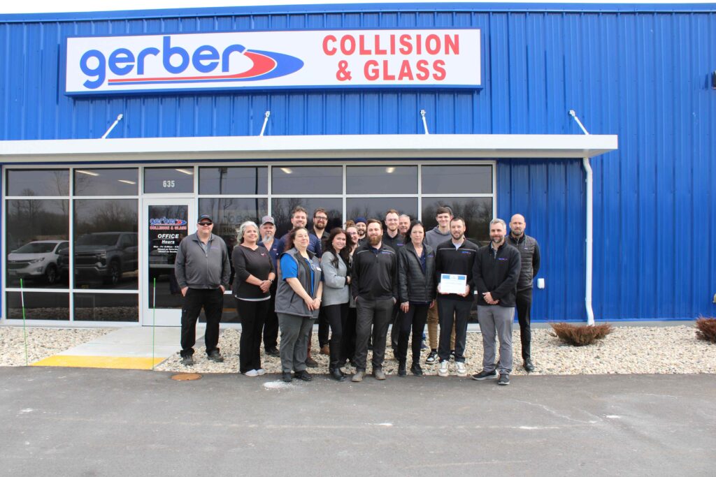 A group of people standing outside for a ribbon cutting