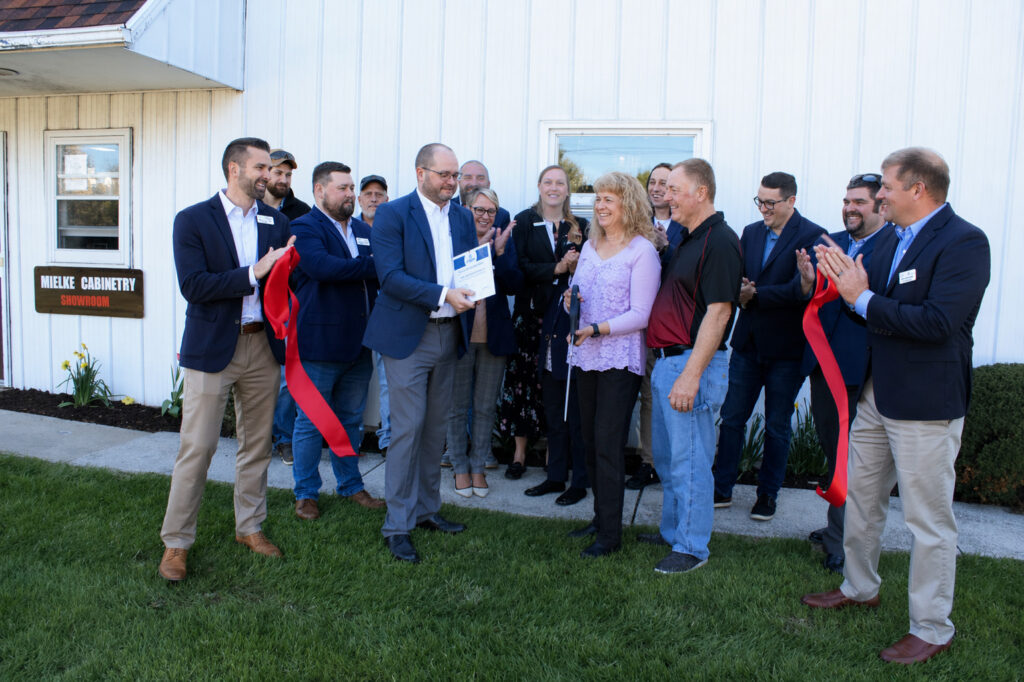 A large group outside for a ribbon cutting