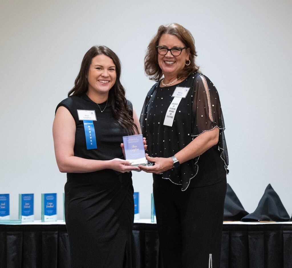 Two women with one getting an award