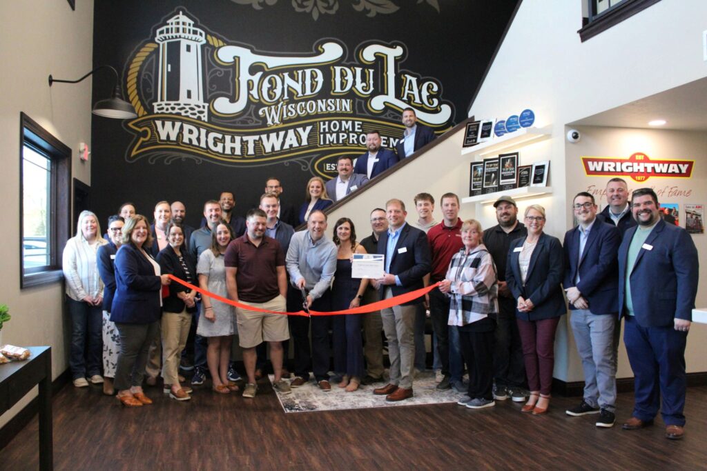 A large group of people inside for a ribbon cutting