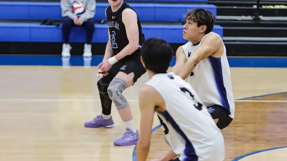 Men playing college volleyball