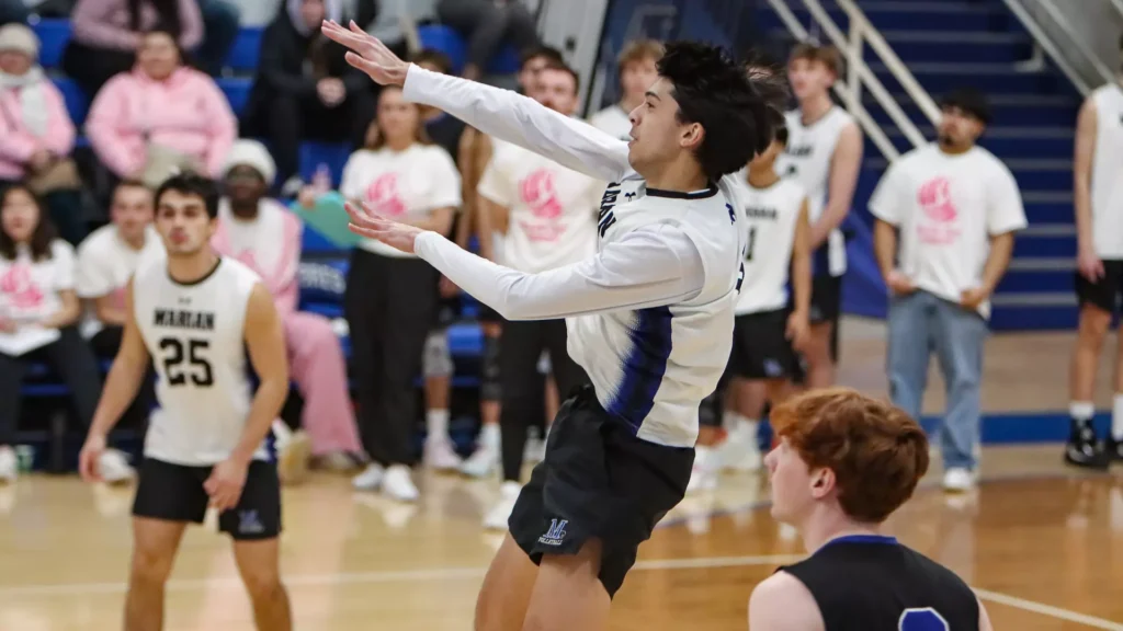 A man playing college volleyball