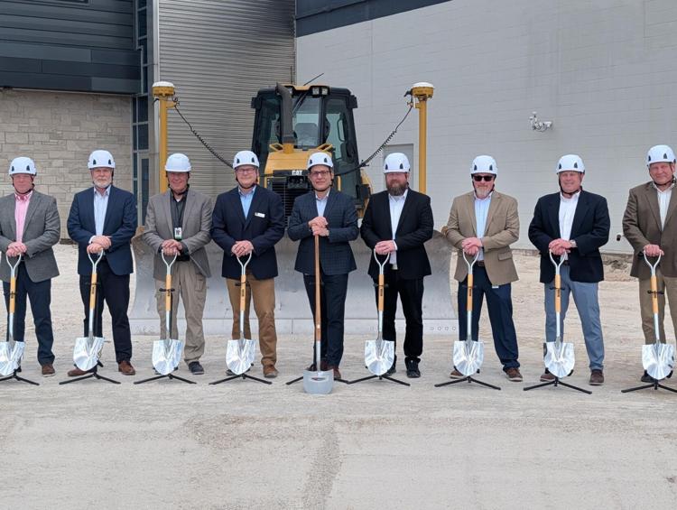 A group of people with shovels and hardhats for a ceremonial ground breaking