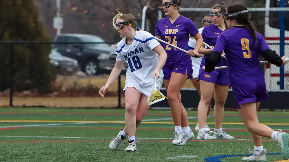 women playing college lacrosse