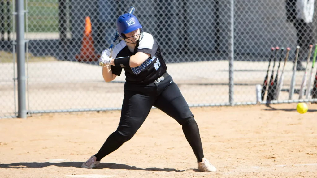 A woman playing college softball
