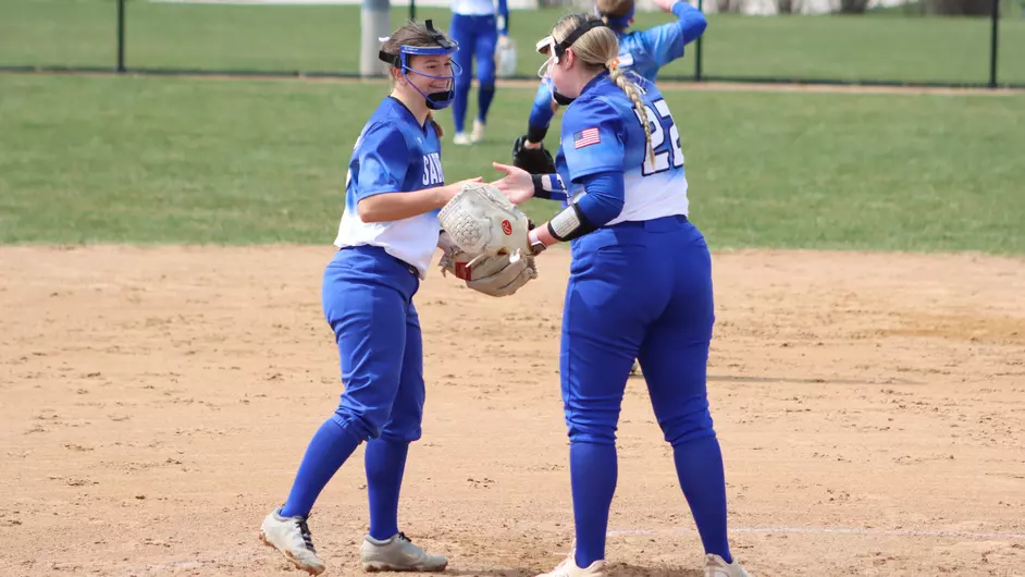 Two female college softball players