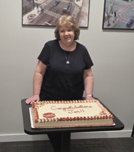 A smiling woman with a cake