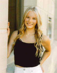 A smiling young woman standing