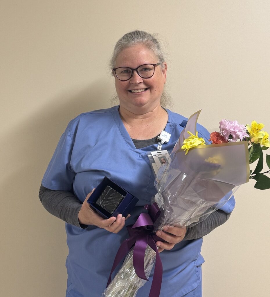 A female nurse holding a bouquet of flowers