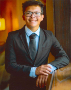 A smiling young man in a suit
